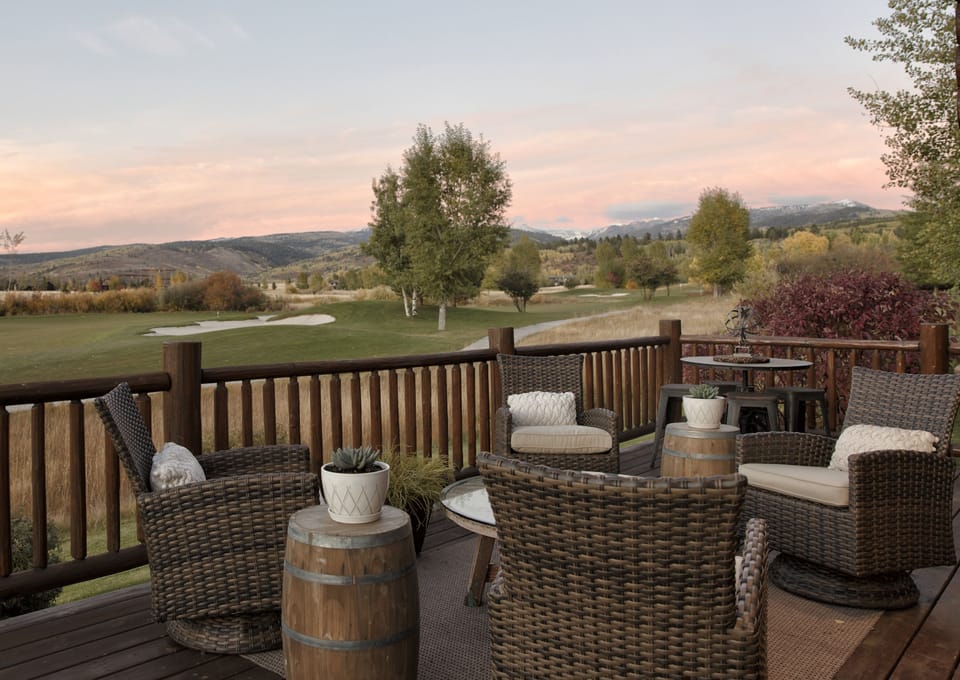 Unwind on your private deck where cozy wicker seating and rolling hills create the perfect backdrop for morning coffee or sunset cocktails with stunning golf course and mountain views.