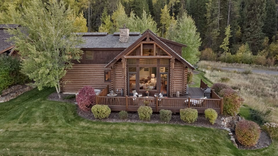 Your stunning log cabin retreat awaits, nestled among towering evergreens with a spacious deck perfect for morning coffee and evening stargazing. Feel the warmth of rustic wood and glass welcoming you home.