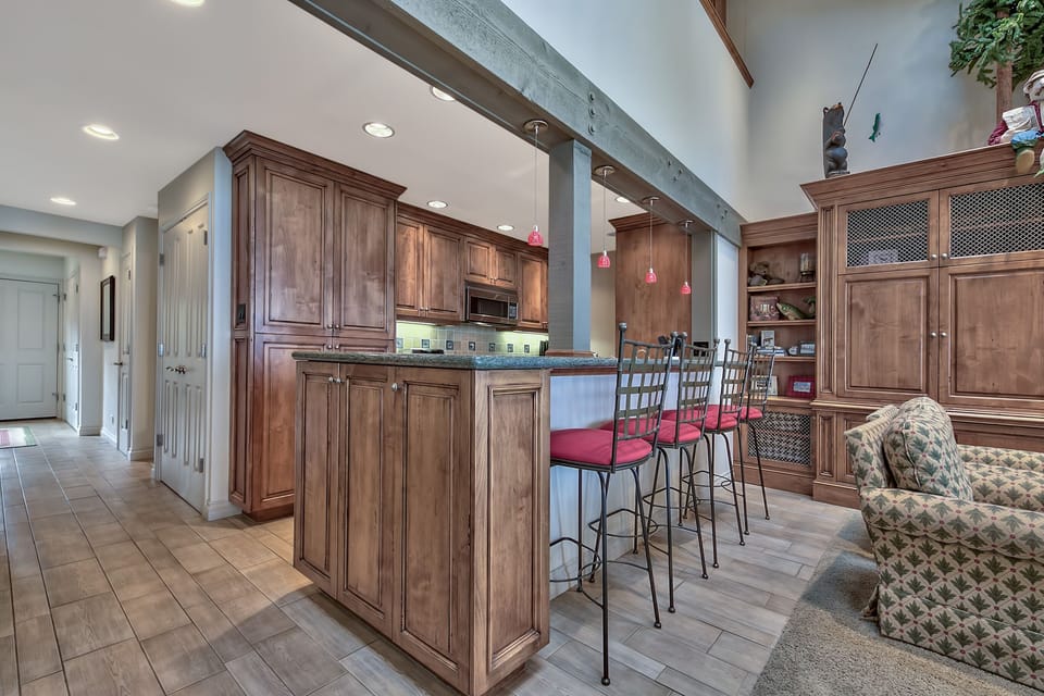 Gather at the spacious island for morning coffee or evening drinks, surrounded by beautiful wood cabinetry and modern comforts.
