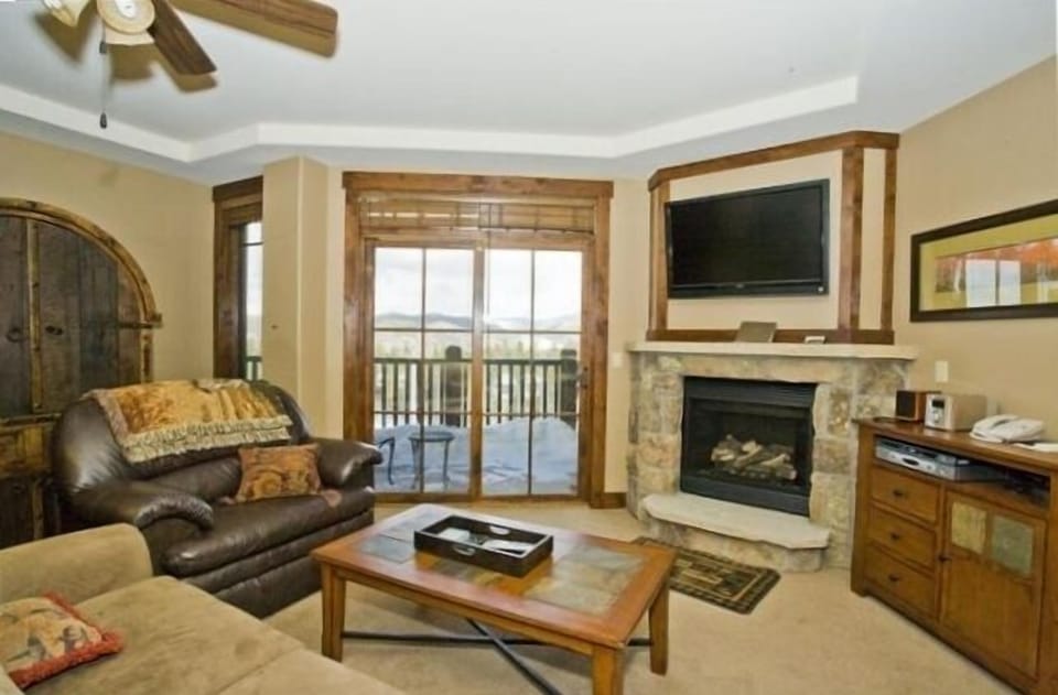 Warm Living Area with a Moss Rock Fireplace