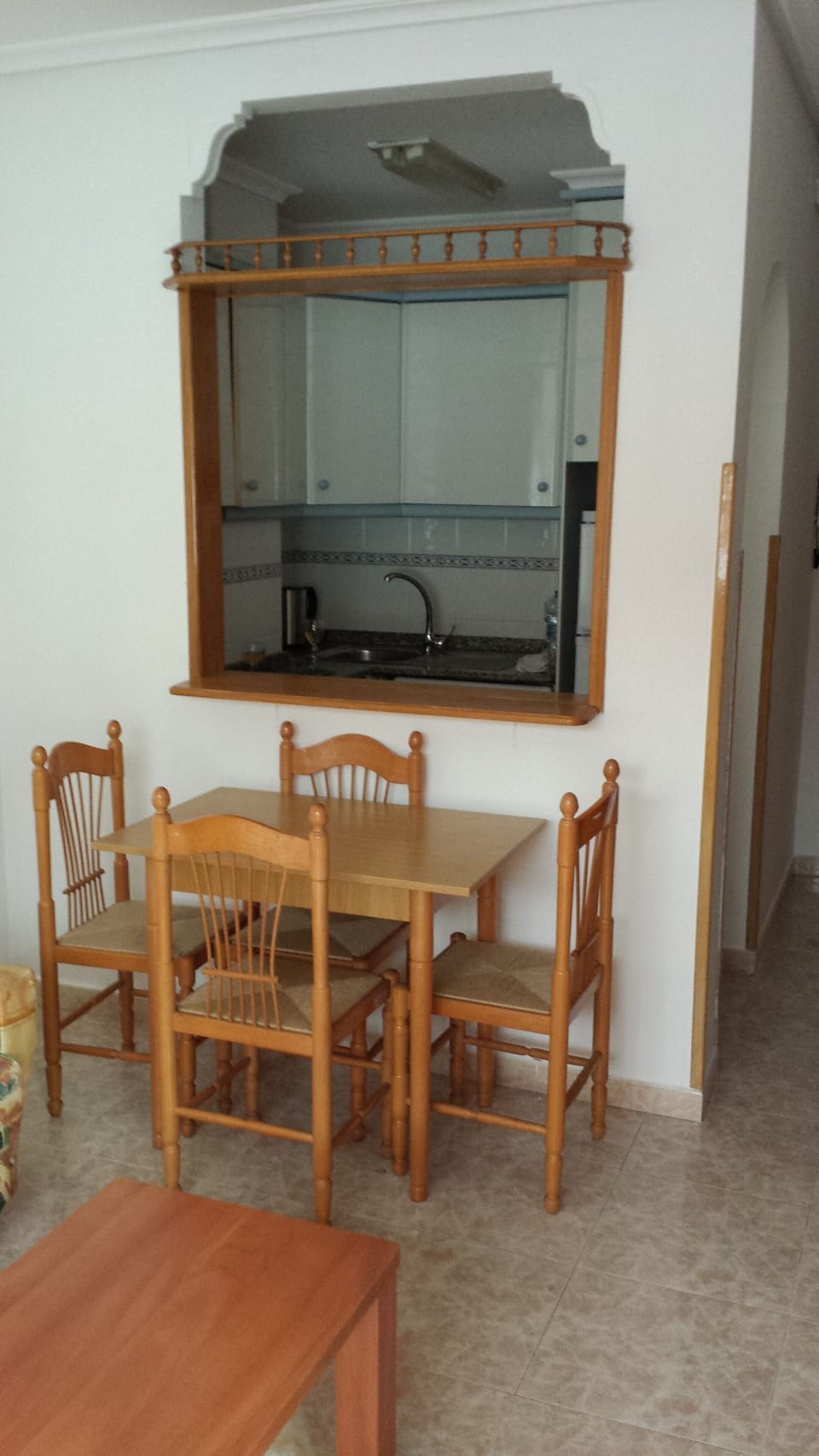 The dining area and archway to kitchen.