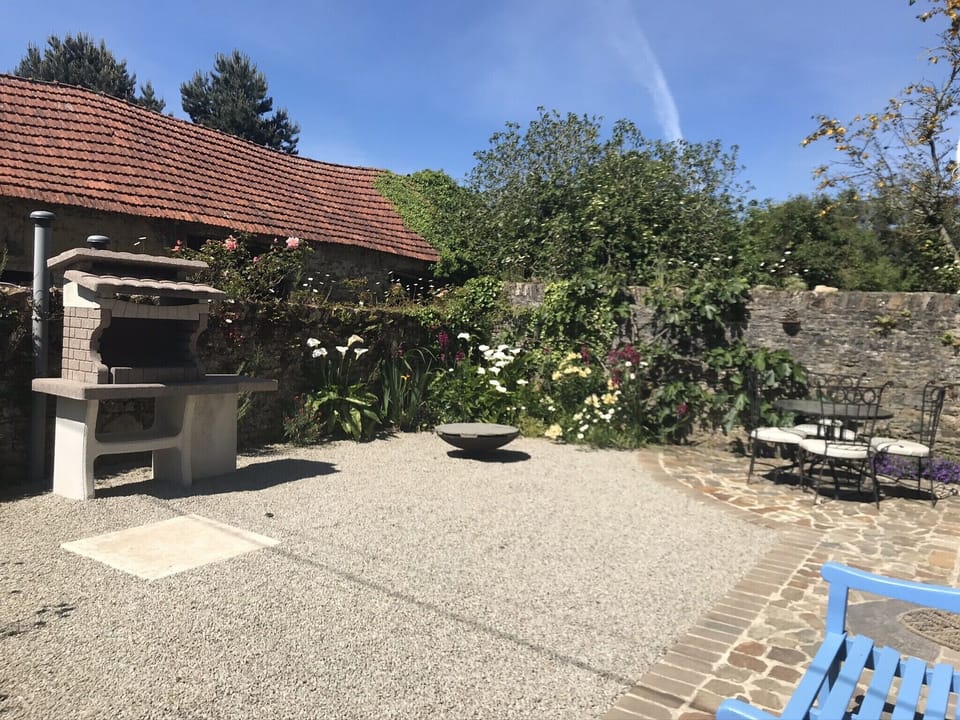 The front South facing courtyard - a real sun trap. Large BBQ and fire pit too.