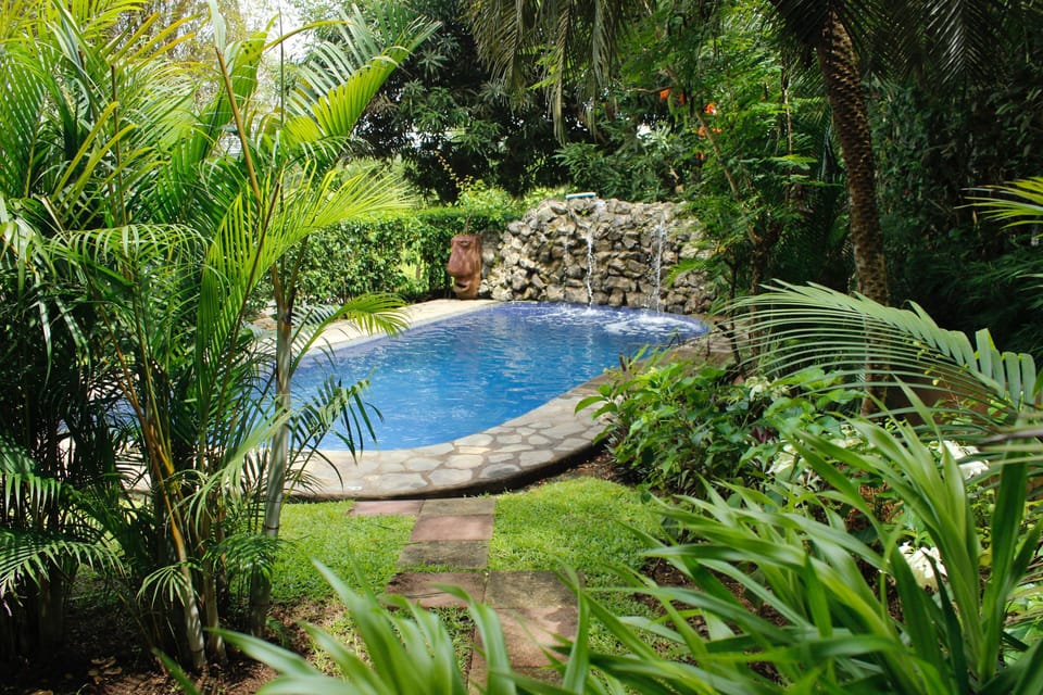 The condos private stone trail onto the tropical garden and deep water pool.