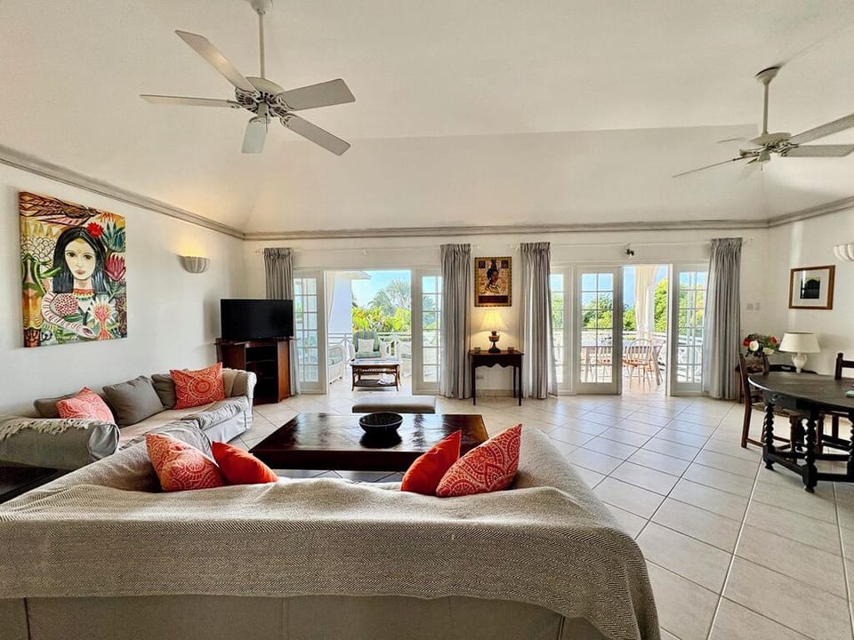 Large living room with fans, smart TV and French doors to terrace with Sea Views