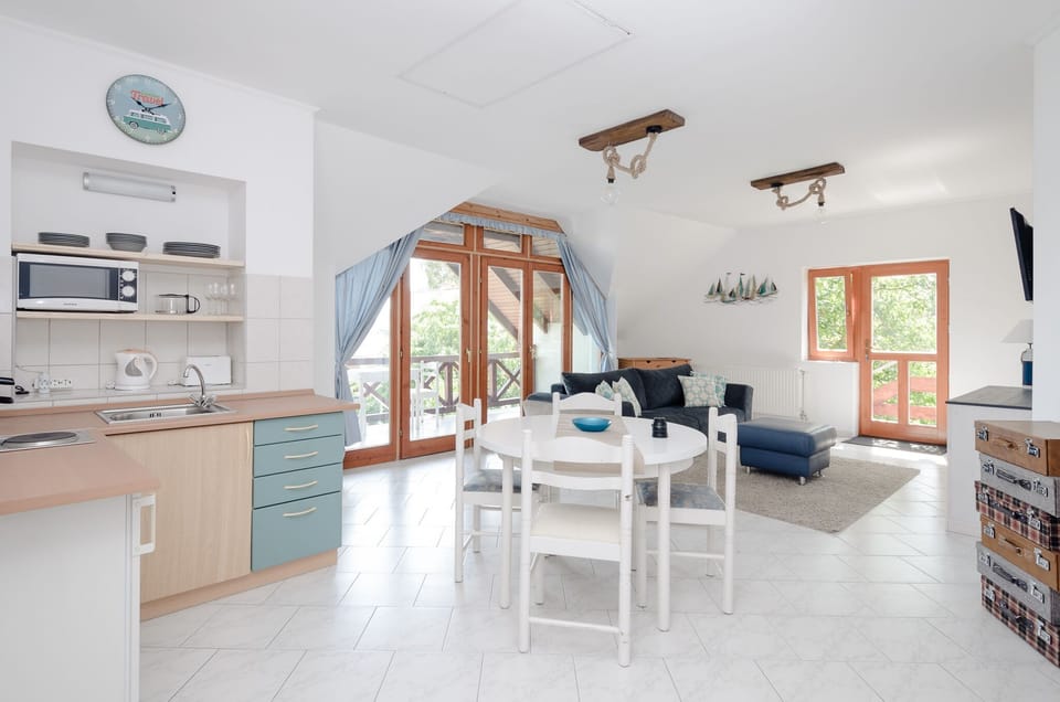 One-space living-room with kitchen, doors to terraces