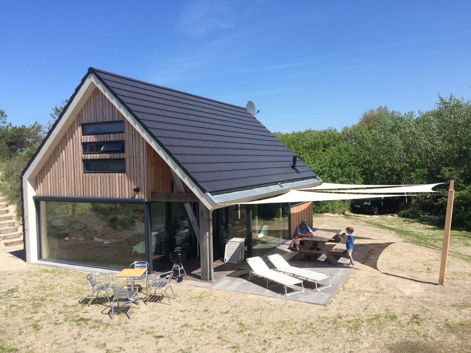 Sun-drenched spacious location amidst the sandy dunes by the seaside.