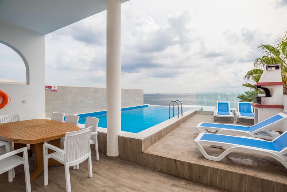 Outdoor Relaxation Area equipped with; table, chairs, Barbecue and Sun Loungers 