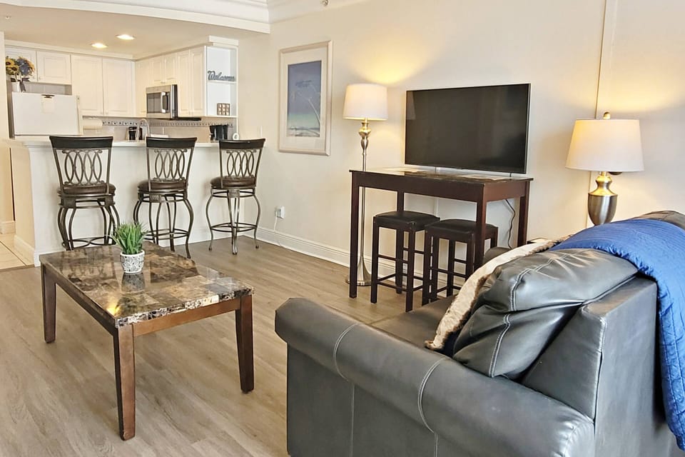 Living area features a 40 inch smart television with satellite TV.