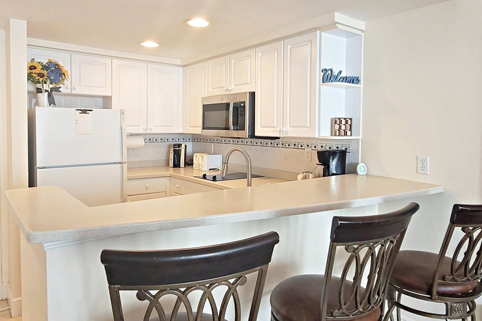 Conveniently equipped kitchenette with full size refrigerator with ice-maker, microwave, 2 top burner stove, toaster and coffee maker.