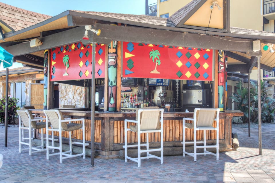 The Tiki Bar & Grill on the pool deck offers cold drinks and light food while providing live entertainment during the summer.