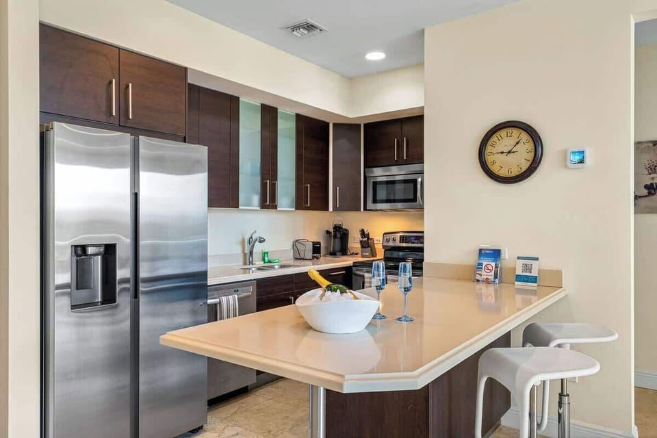 The kitchen is modern with lots of cabinets