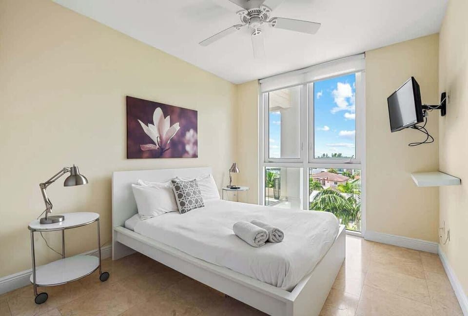 The guest bedroom has a Queen-size bed and a flat screen TV.