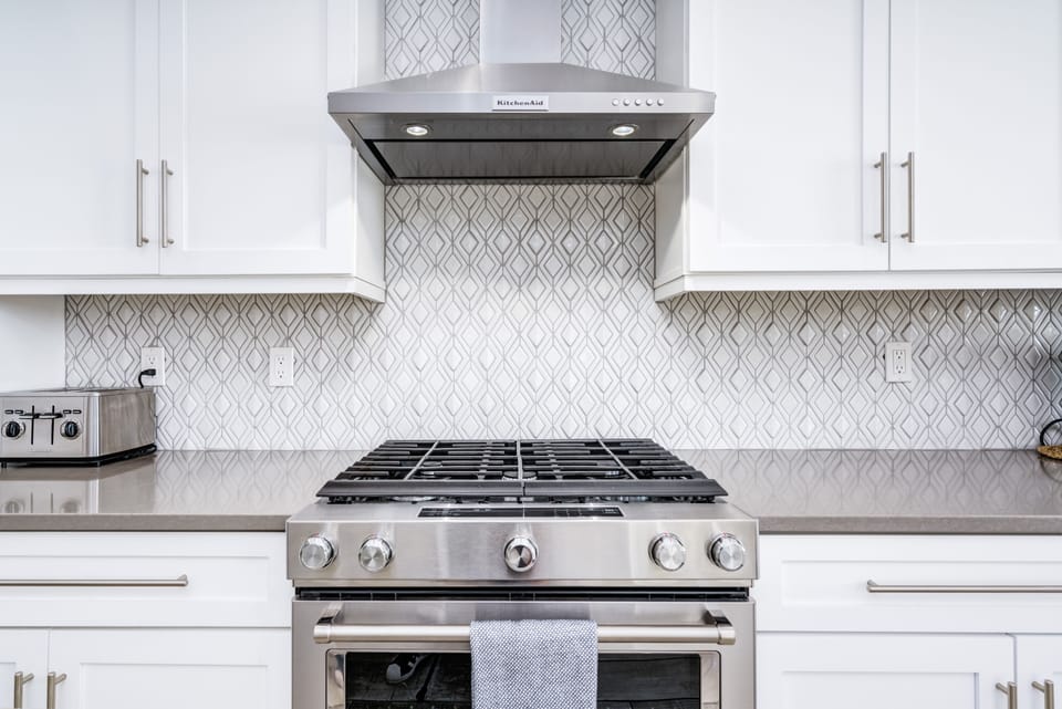 Cook your favorites while on vacation in this stunning kitchen with a gas range.