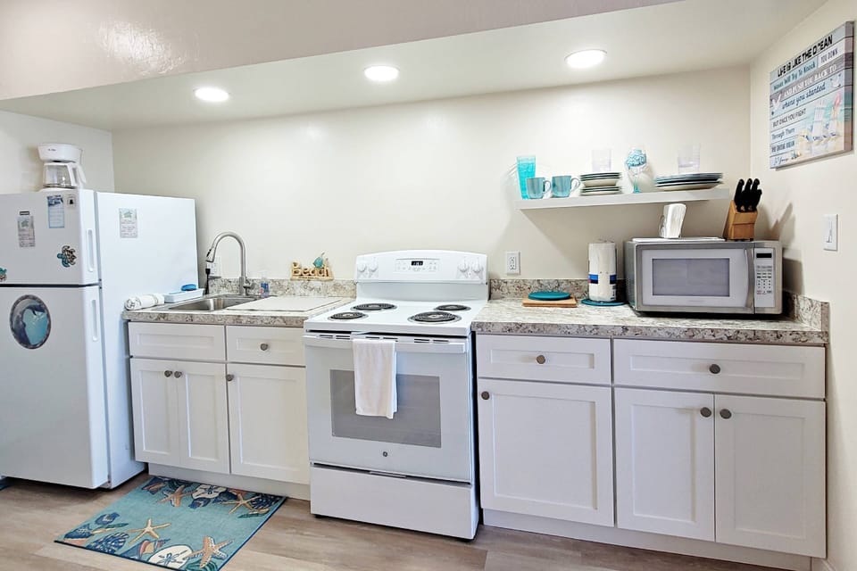 Kitchenette with full size refrigerator, stove, oven, microwave, coffee pot, etc. to save on meals.