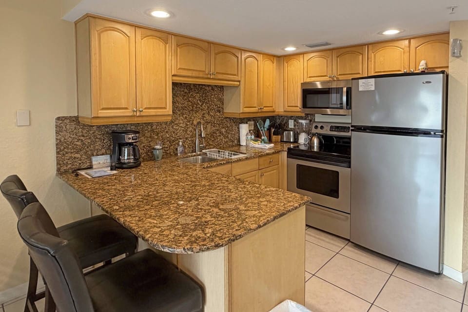 Fully equipped kitchen with granite countertops and stainless-steel appliances