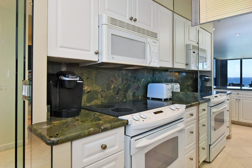 Full size appliances and stocked with blender, toaster, and coffee maker.