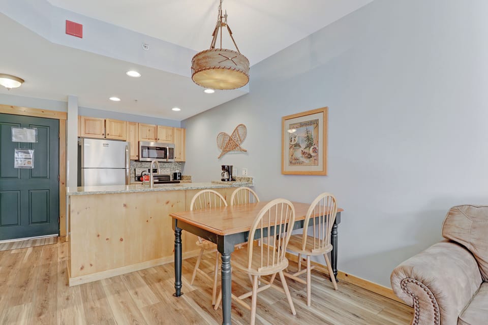 Step into your cozy mountain retreat where rustic charm meets modern comfort. You'll love gathering around the farmhouse dining table while the beautiful woven pendant light creates a warm, inviting glow above.
