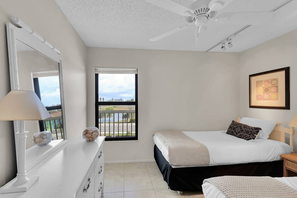 A chest of drawers, mirror & ceiling fan finishes off the guest bedroom