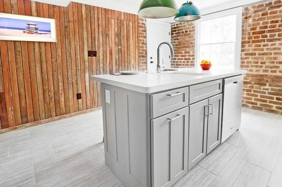 Reclaimed wooden walls and exposed brick give this home its eclectic fun atmosphere.