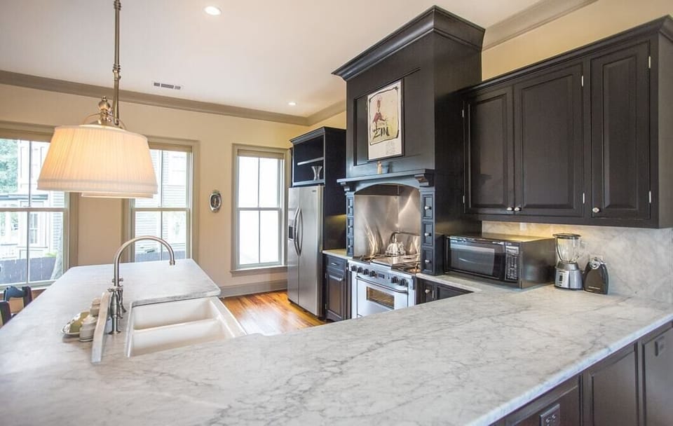 Luxury gas stove top and side by side stainless steal refrigerator.