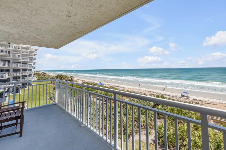 Relax on the spacious, wrap-around corner balcony overlooking no-drive New Smyrna Beach and the inviting Shorehom by the Sea pool