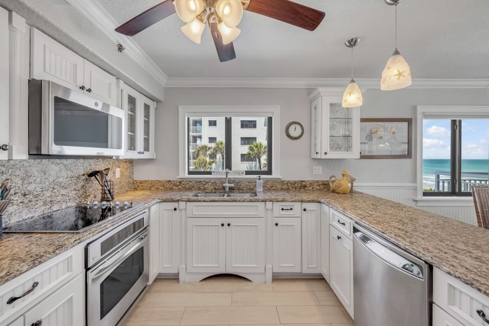 Updated kitchen featuring sleek stainless steel appliances and a pool view