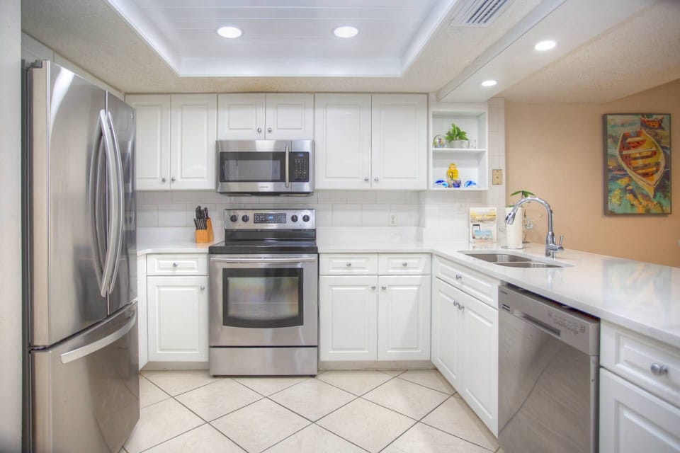 Quartz Countertops with Stainless Steel Appliances Featuring French Door Refrigerator