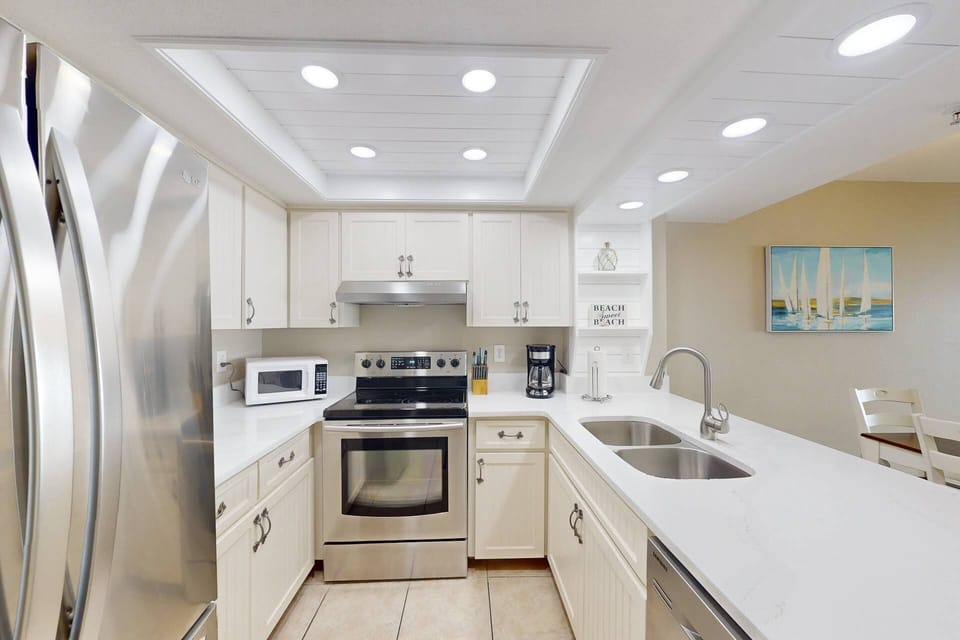 Fully equipped Kitchen with stainless steel appliances featuring French door refrigerator