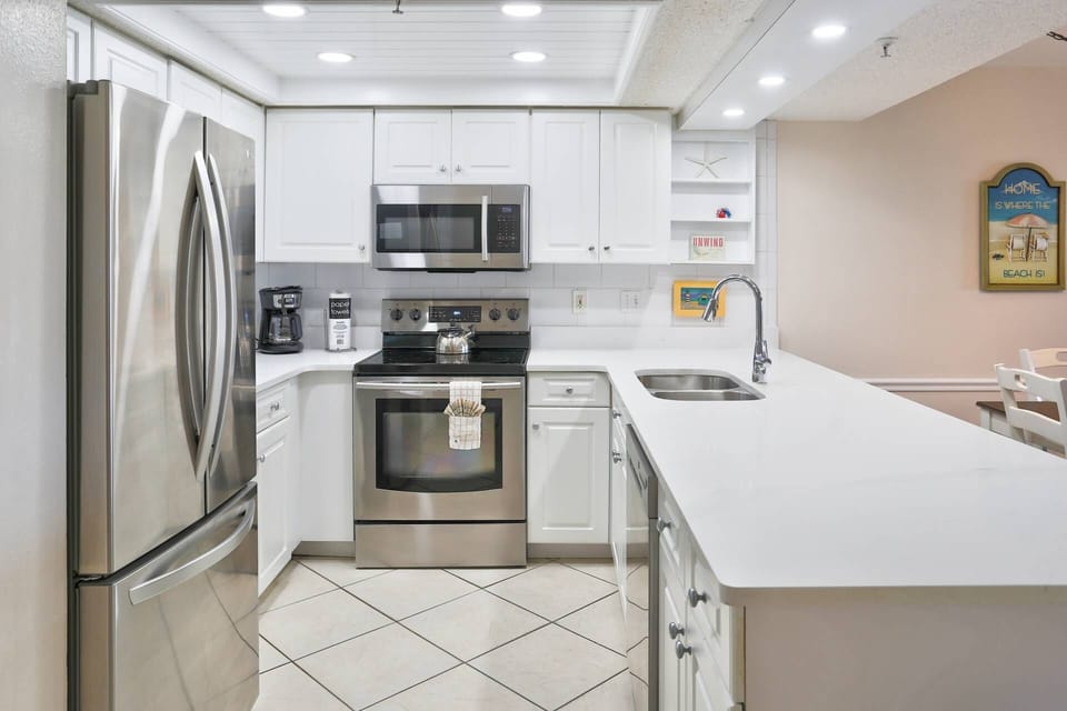 Updated Fully Equipped Kitchen Featuring a French Door Refrigerator