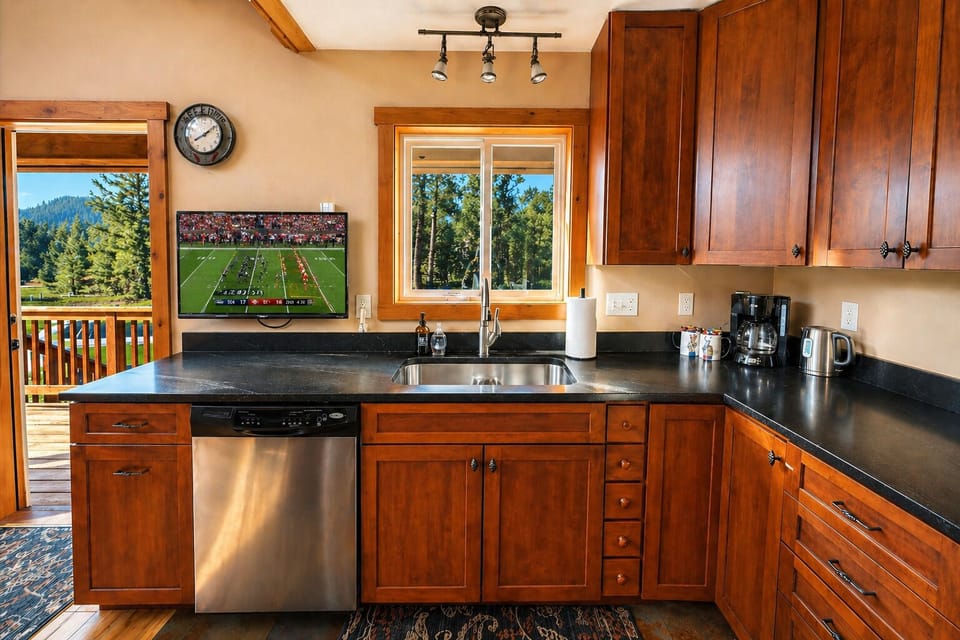 Kitchen with dishwasher and TV