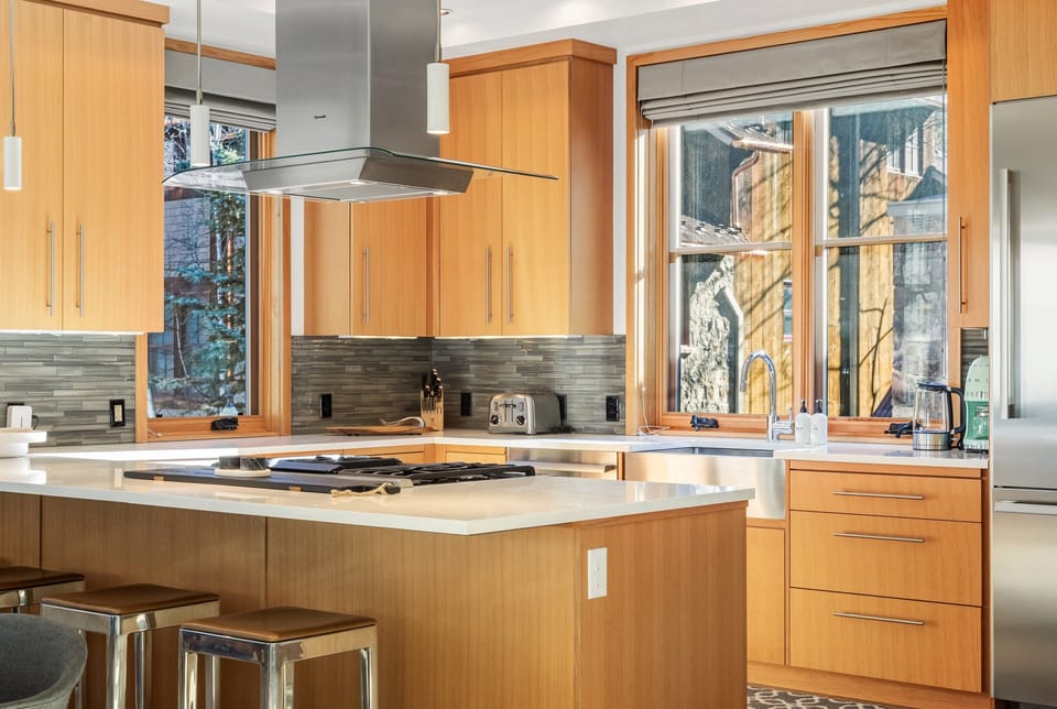 The oversized kitchen island provides comfortable seating for four, perfect for relaxed morning meals.