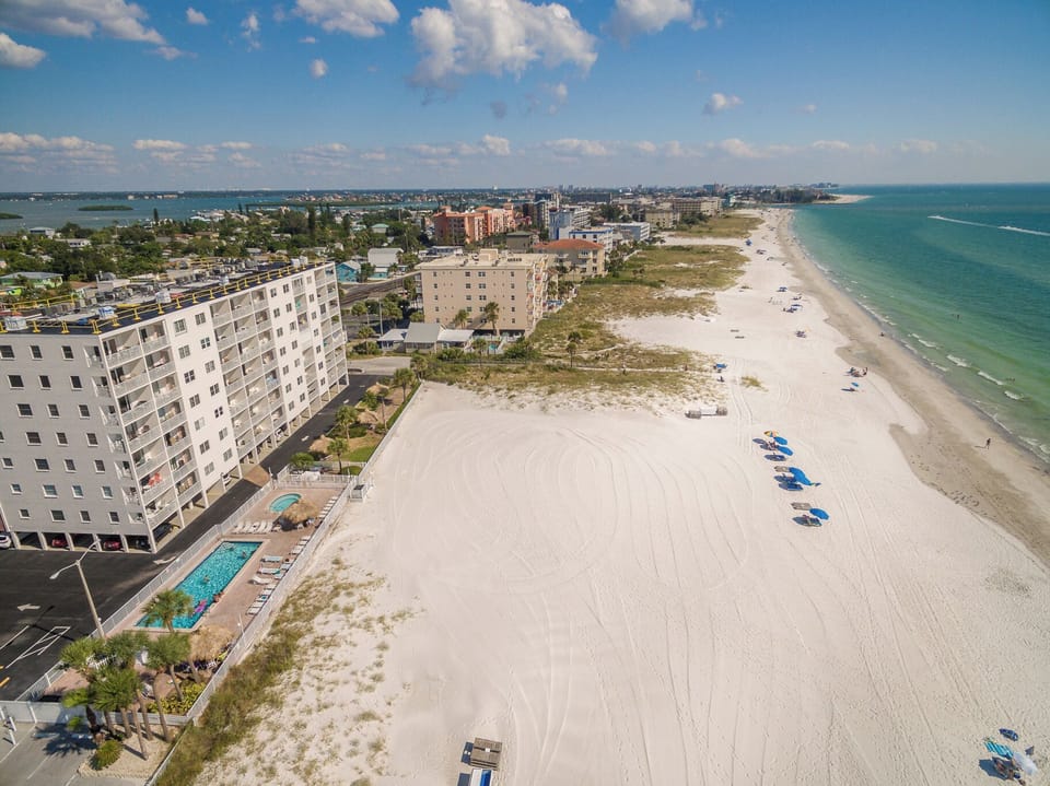 Beachfront property with direct sand access and stunning Gulf Coast location featuring swimming pool and pristine white sand beach.
