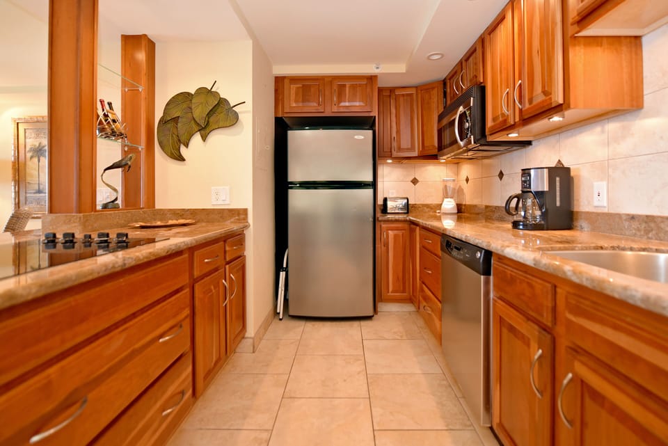 Fully equipped kitchen has microwave (no oven) with stainless steel appliances