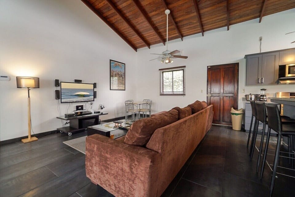 Living room with flatscreen TV and Home Theater, L-shaped sofa.