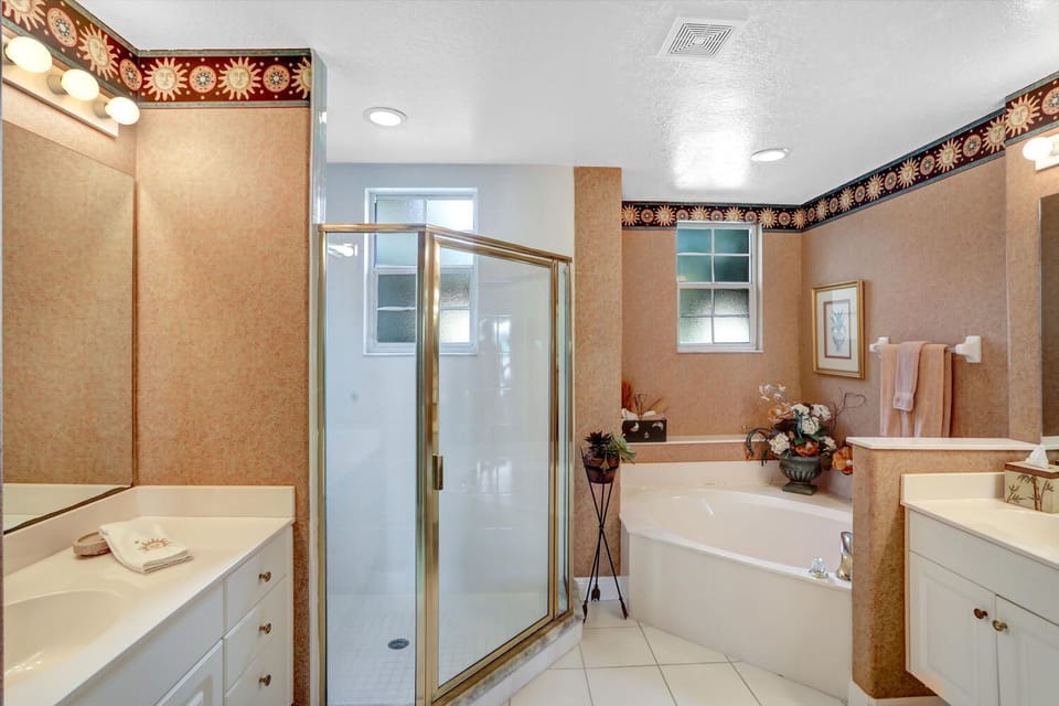 VY693-16B - The en-suite master bathroom features a spacious walk-in shower, roman tub and dual sinks