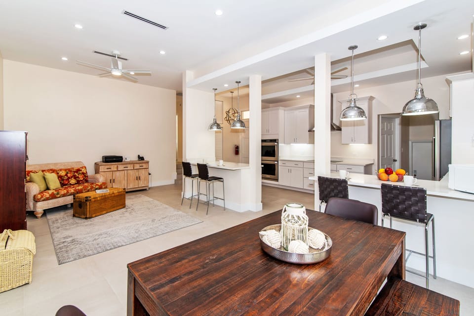 Wide view of the kitchen, second dining area, and a small sitting area.