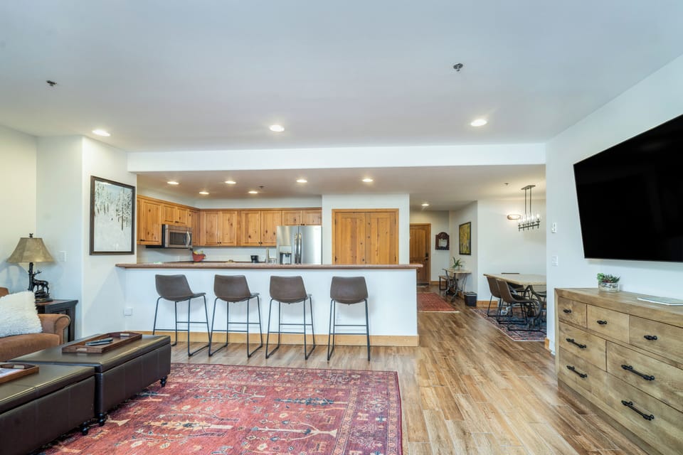 Relax in your open-concept living space where warm wood floors and a spacious kitchen island create the perfect gathering spot for memorable meals.