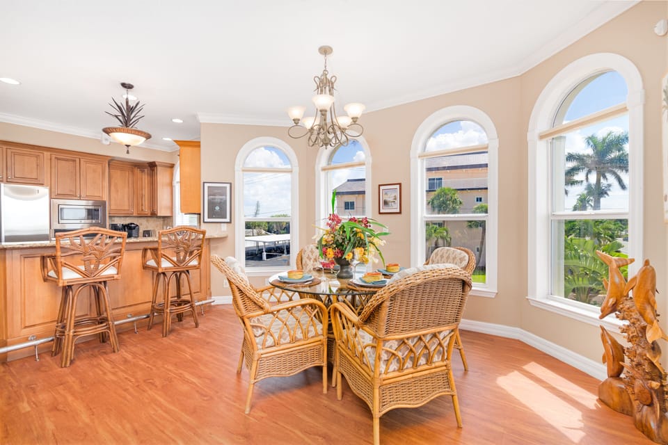 Gather around this stylish table surrounded by elegant arched windows for memorable meals with family and friends.