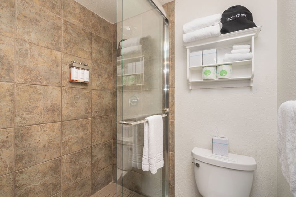 Step into your beautifully tiled walk-in shower, where plush towels, a hair dryer, and thoughtful toiletries await to make you feel right at home.