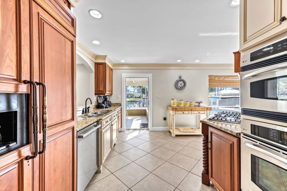 Kitchen with lanai entrance in view - everything you need to cook and connect.