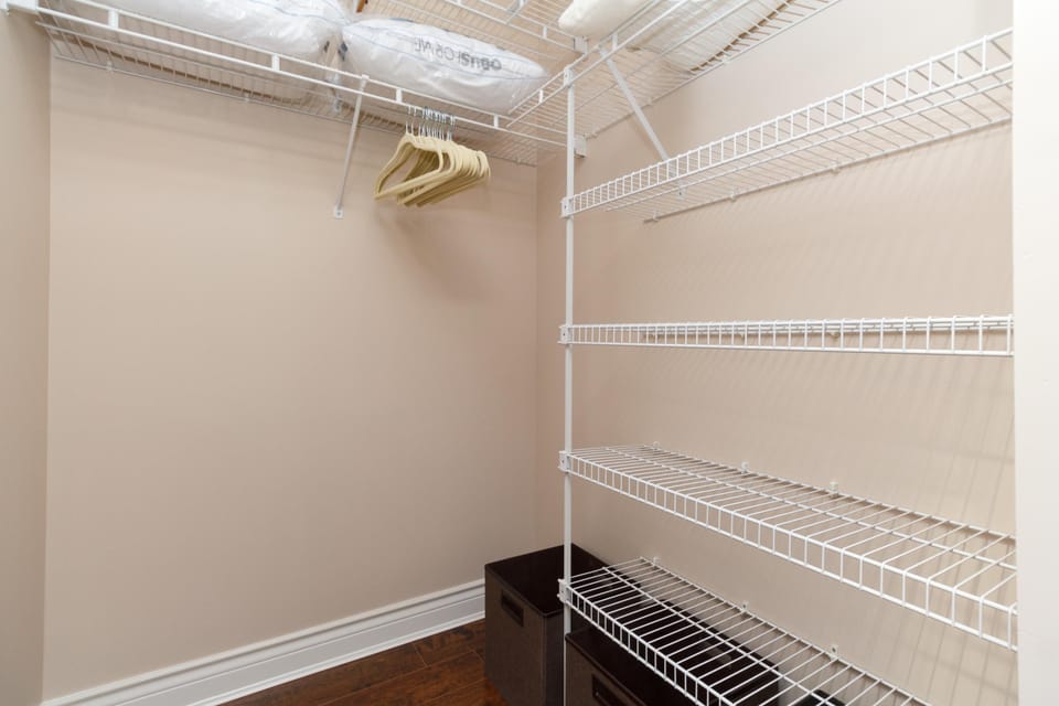 Maximize your wardrobe options with a spacious walk-in closet featuring built-in wire shelving organizers.