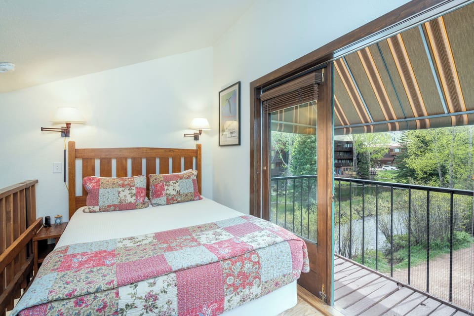 Drift off in this cozy bedroom where your balcony overlooks lush greenery. Warm wood tones, soft linens, and gentle natural light create a peaceful retreat for restful nights.