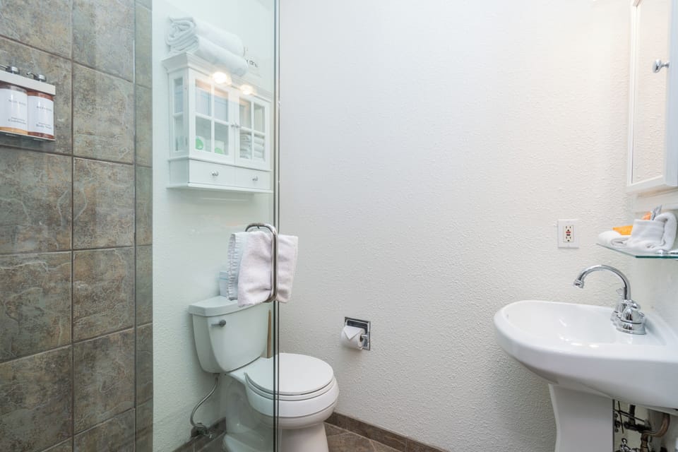 Step into a fresh, light-filled bathroom where your comfort is thoughtfully arranged. Crisp white fixtures and tasteful tile work create a clean retreat for your daily refresh.