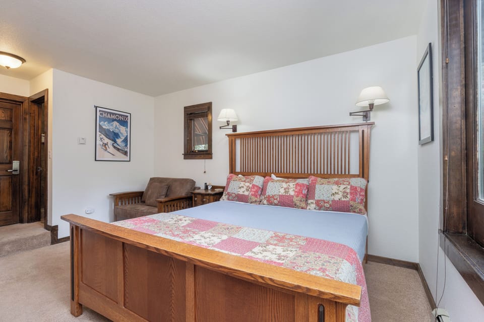 Sink into the cozy bed after a day exploring nearby Chamonix. Your alpine retreat features rich wood furnishings, warm lighting, and all the comfort you need to recharge for tomorrow's adventures.