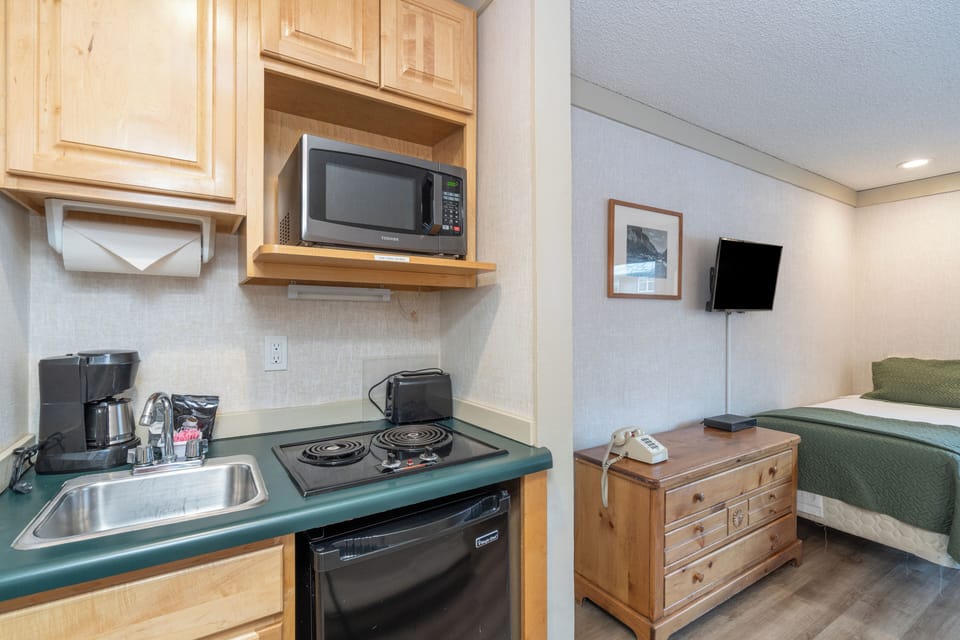 Your studio features a convenient kitchenette with everything you need to prepare quick meals alongside comfortable sleeping space for a perfect getaway.