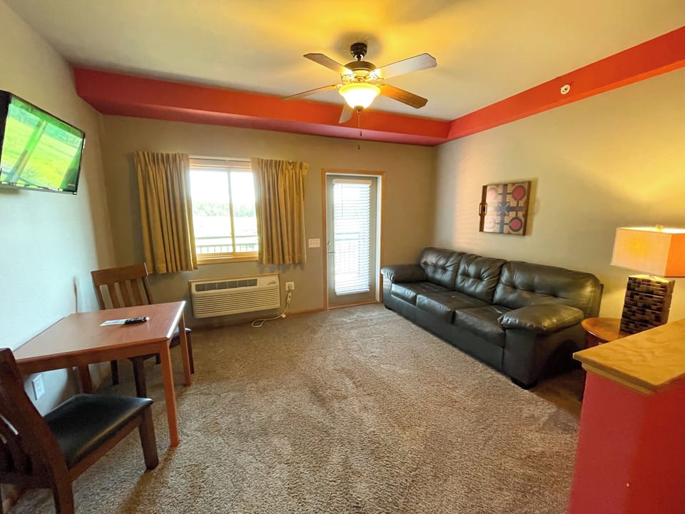 Living Area with Cozy Seating, Queen Sofa Sleeper, TV, Table & Seating