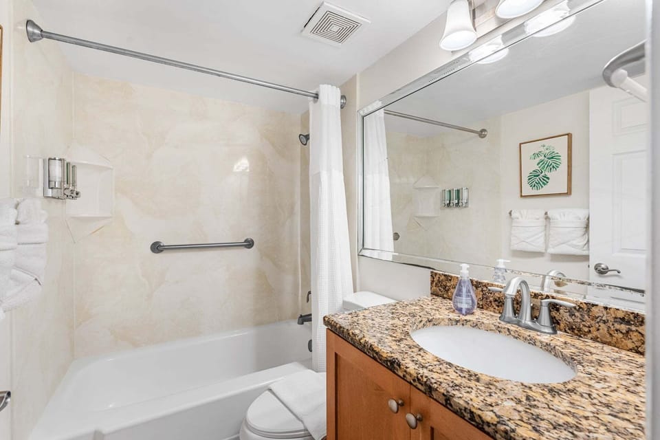 Guest bathroom with granite counters and tub/showe