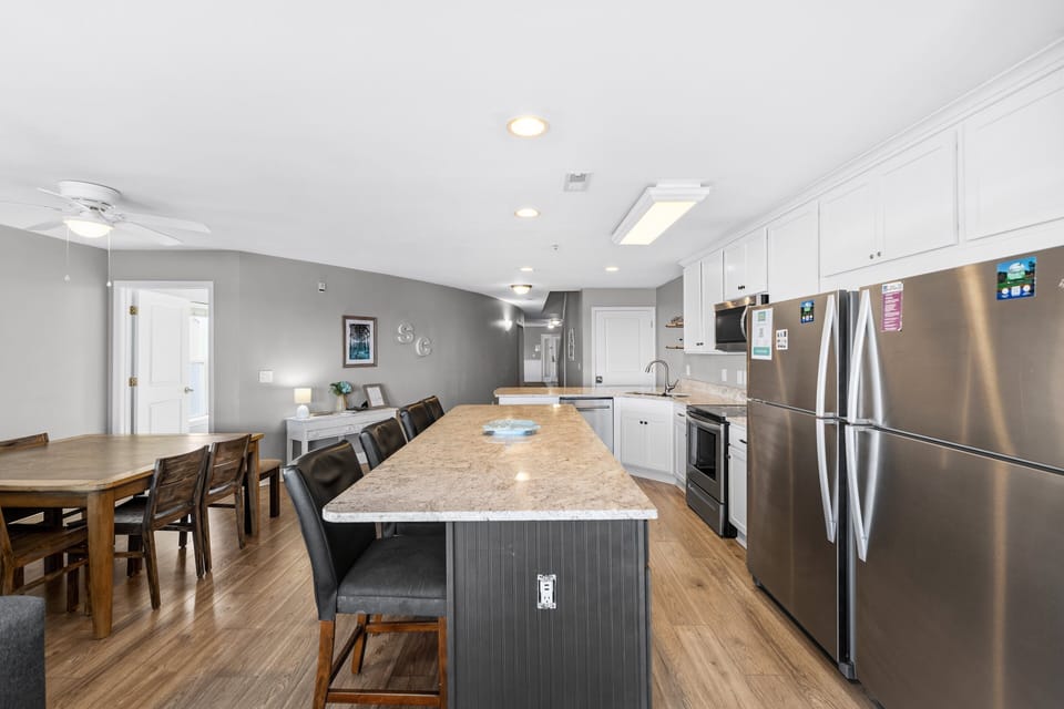 Kitchen - Kitchen with full appliances including refrigerator, stove, and microwave, along with cookware for preparing meals.