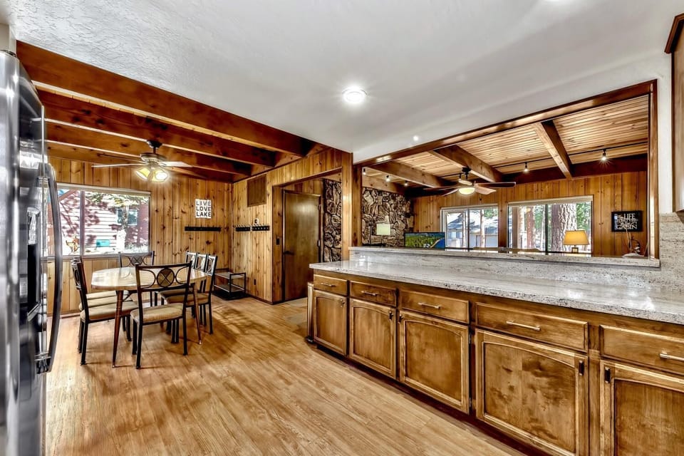 Your rustic kitchen awaits with warm knotty pine cabinets, granite counters, and charming exposed beams for cozy mountain cooking.
