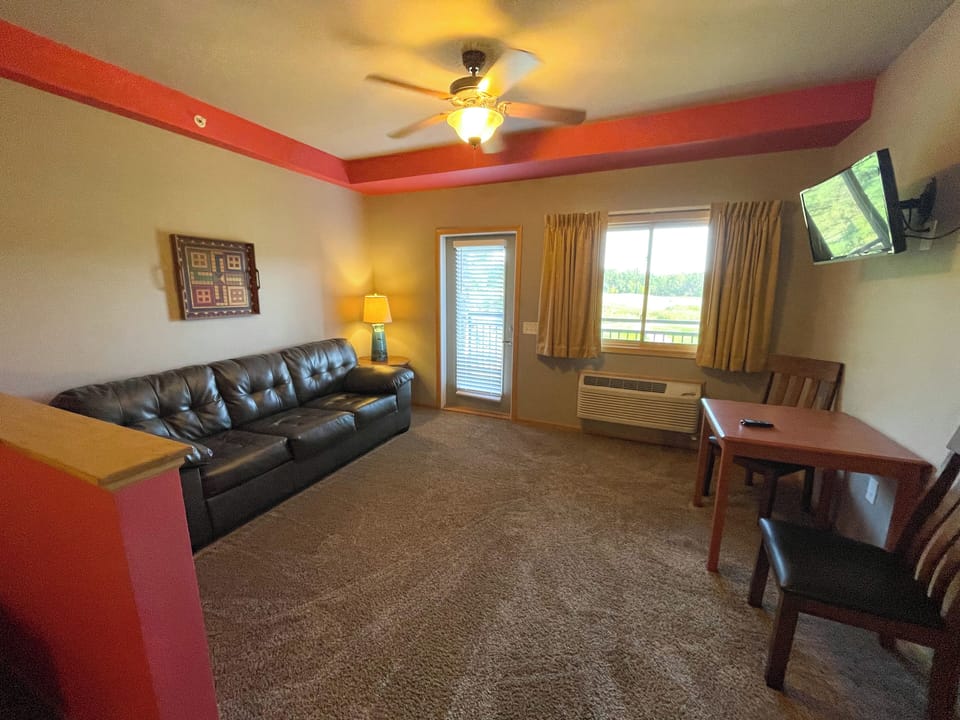 Living Area with Cozy Seating, Queen Sofa Sleeper, TV, Table & Seating